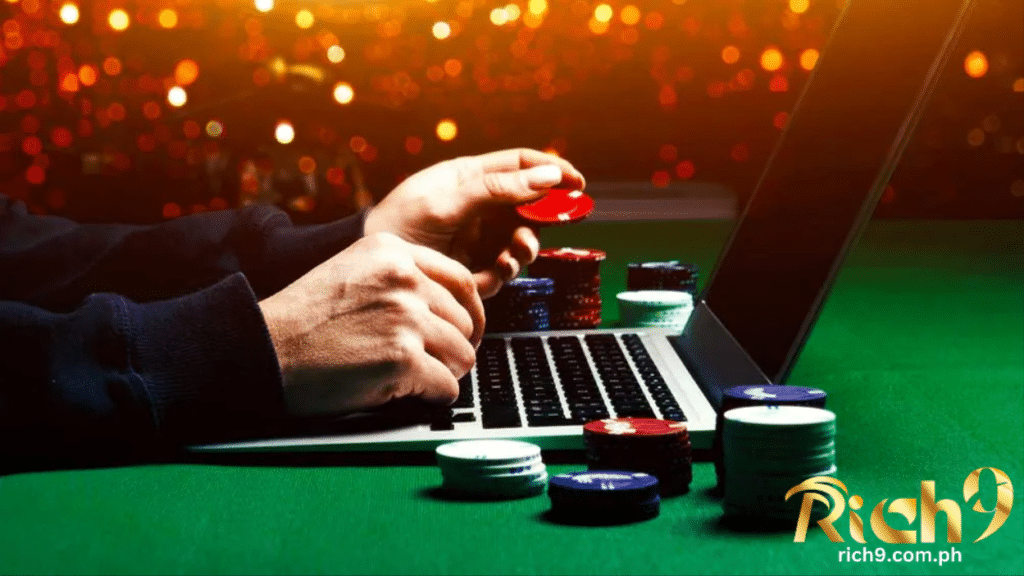 isang kamay na gumagamit ng laptop upang maglaro sa online casino